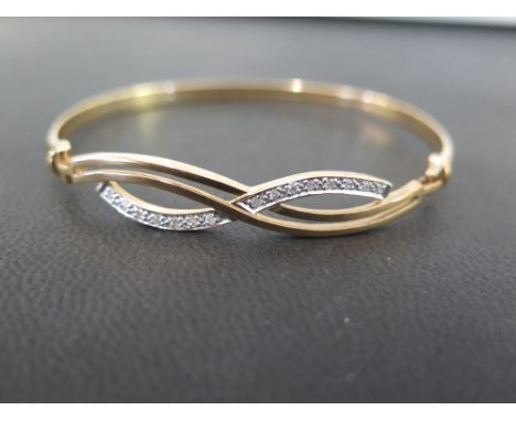 A brilliant-cut diamond set hinged bangle - Of twist design - Stamped 9K - Inner diameter 6.5cms - Weight approx 7.3gms
Condi