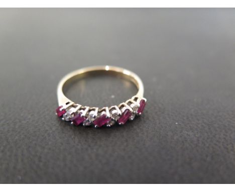 A 9ct gold baguette-cut ruby and brilliant-cut diamond dress ring - Hallmarked Birmingham - Ring size P 1/2 - Weight approx 1