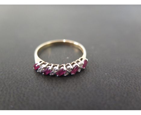 A 9ct gold baguette-cut ruby and brilliant-cut diamond dress ring - Hallmarked Birmingham - Ring size P 1/2 - Weight approx 1