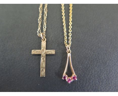 A 9ct gold ruby-set pendant - Suspended from a belcher-link chain - Length of pendant 2cms - Length of chain 46cms - Together