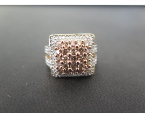 A 9ct gold diamond cluster ring - The square-shape panel set with champagne-colour brilliant-cut diamonds, to the single-cut 