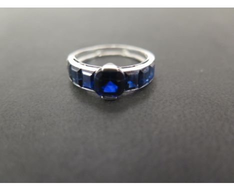 A deco style sapphire and diamond ring - The octagonal-shape central sapphire with rectangular-shape sapphire shoulders, each