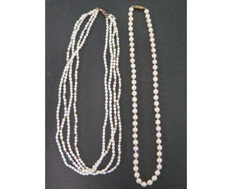 A cultured pearl single-row necklace - To the oval clasp, stamped 375 - Length 43cms - Together with a multi-strand freshwate