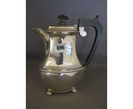 A hallmarked silver coffee pot standing on four bun feet with ebony handle and finial - hallmarked Chester 1931 - total appro