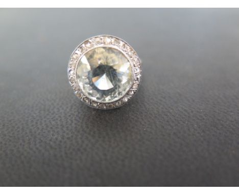 An aquamarine and rose-cut diamond cluster ring - Tests as higher carat gold - Ring size M - Aquamarine diameter approx 12mm 