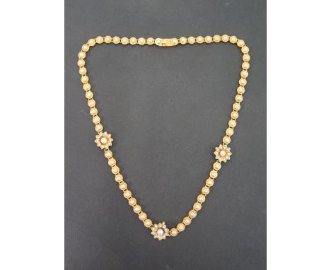 A seed pearl panel necklace - With three seed pearl floral clusters to the circular seed pearl panels - Tests as higher carat