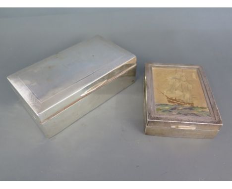 A weighted silver desk top cigarette box with engine turned decoration and another weighted silver cigarette box with a petit