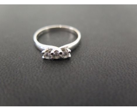 A platinum and diamond three-stone ring - Estimated total diamond weight 0.25ct - Hallmarked Birmingham - Ring size O - Weigh