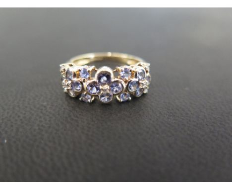 A 9ct gold tanzanite and diamond triple cluster band ring - Hallmarked Birmingham - Ring size S - Weight approx 3.3gms
Condit