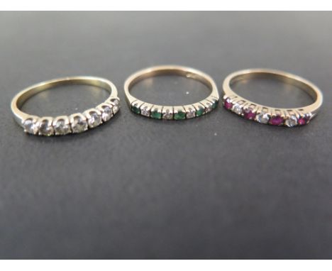 Three gem-set seven-stone rings - To include ruby, emerald and diamond - Two with 9ct gold hallmarks - One tests as gold - Ri