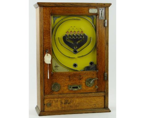 An oak cased Vintage Arcade pinball machine,
in working order, height 25.5".
