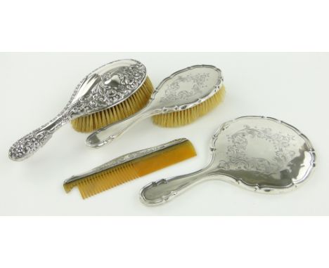 Silver backed hand mirror,
2 silver backed brushes and a silver mounted comb, (4).