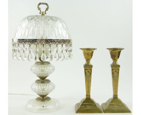 A cut-glass table lamp and shade,
16.75" and a pair of embossed brass candlesticks.