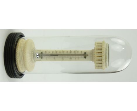 A Victorian carved ivory thermometer
on turned hardwood base, with inset compass under glass dome, height 6.75" overall.