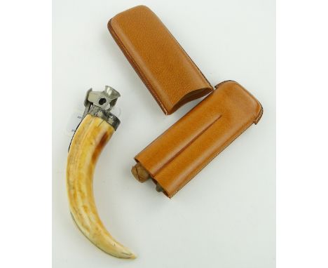 A continental silver Wild Boar tusk cigar cutter,
marked 925S, and a leather cigar case with Havana cigars, (2).