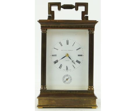 A brass cased carriage clock with alarm,
dial signed Matthew Norman, London, height to handle 7.25".