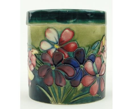 A Vintage Moorcroft jar and cover
with tube-lined flowers, signed, with original paper label, height 3.5".