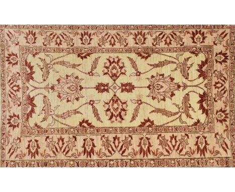 'Afghan Ziegler' wool rug, the beige field with red Persian style flowerheads, 188cm x 124cm (sold with 2004 receipt for £685