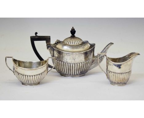 Matched three-piece silver bachelor's tea set of gadrooned form, consisting of milk boat, sugar bowl and teapot, the teapot b