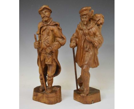 Pair of Black Forest carved figures of two gentlemen, one smoking a pipe, the other carrying a lamp and staff, 48cm high (2)