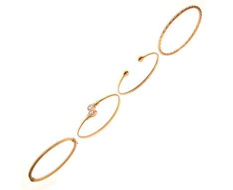 Four gold bangles, comprising an amethyst and diamond 9ct gold torque bangle, a 9ct gold hollow torque bangle, a 9ct gold ova