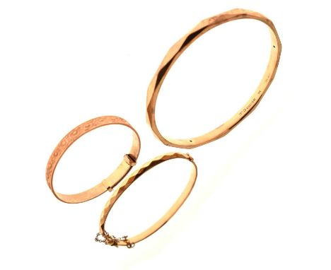 Three bangles comprising a 9ct gold-filled bangle, a 1/5th 9ct rolled gold expanding bangle, and a 9ct metal core hinged bang