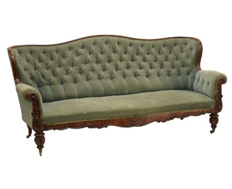 Early to mid 19th century carved mahogany settee or sofa, the deep-buttoned serpentine back and sprung seat between overstuff