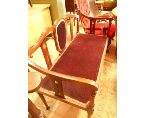 An Art Nouveau walnut salon sofa, the shaped top rail with mother of pearl inlaid splat's and scrolling arms over a padded se