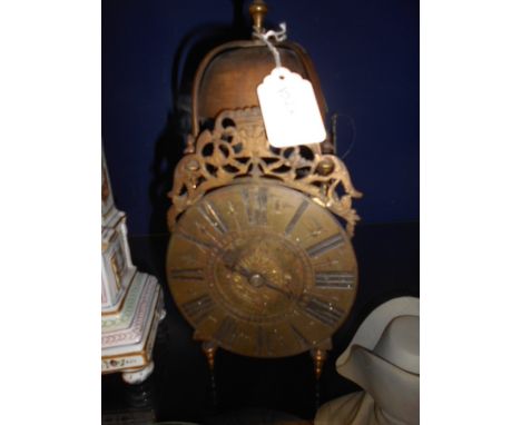 A 19th C brass lantern clock with pierced bird and scroll gallery  Key wound, glue repair to scroll work, tarnished and untes