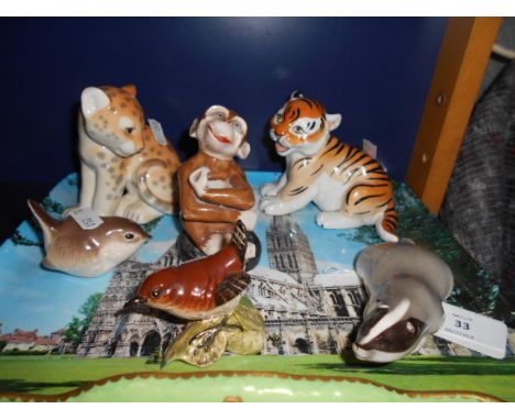 A USSR tiger and leopard cubs, a USSR badger and wren and a Beswick wren plus a ceramic monkey