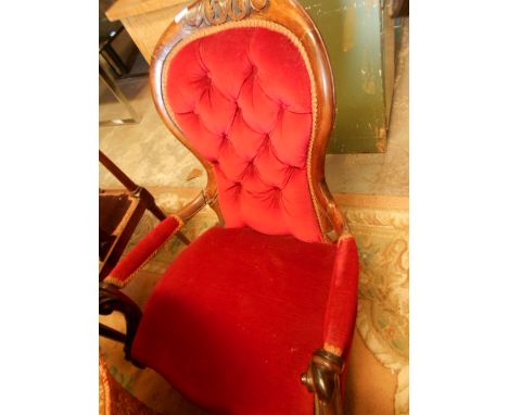 A Victorian mahogany framed spoon back floral carved armchair in red upholstery (A/F)