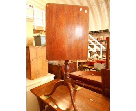 A Victorian mahogany tilt-top side table the rectangular top with canted corners raised on a turned column support and tripod