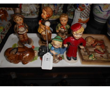 A collection of Goebel figures to include an unusual bell boy No. N32A, a small seated dog, a Mabel Lucie Attwell hiking girl