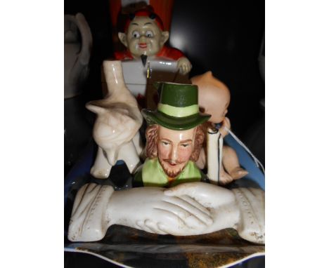 A ceramic playing card box surmounted with a devil, three piano babies, a pie funnel in the form of an elephant and a Sylvac 