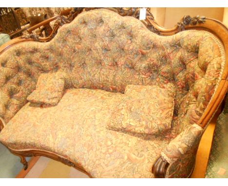 A 19th C carved rosewood framed salon sofa with button-back upholstery resting on short cabriole legs