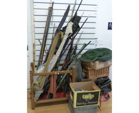 A large collection of vintage fishing tackle including bamboo rods, telescopic rods, trout and spinning rods, holdalls, bank 