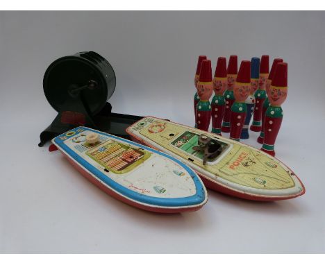 A quantity of vintage toys including two clockwork boats, a vintage Rolette machine and a quantity of vintage painted skittle