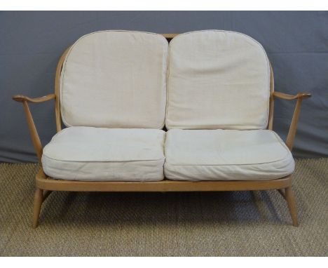 A light elm Ercol sofa, length 134cm