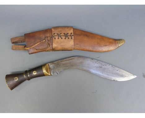A WWI Gurkha kukri in sheath, marked to blade with broad arrow and 1917 in sheath 