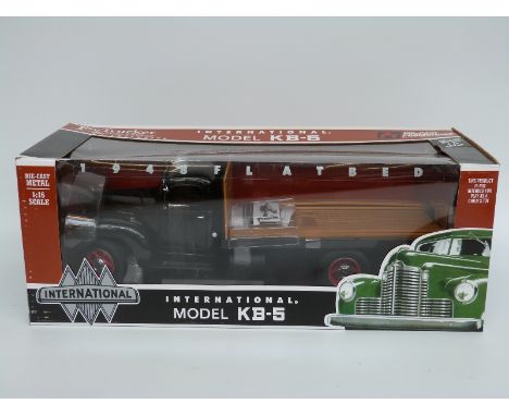 ERTL 1:16 scale diecast model International Model KB-5 flatbed truck, in original box