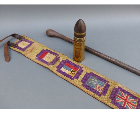 First World War leather belt embroidered with flags of the Allies together with a 1911 shell and a WWI swagger stick 