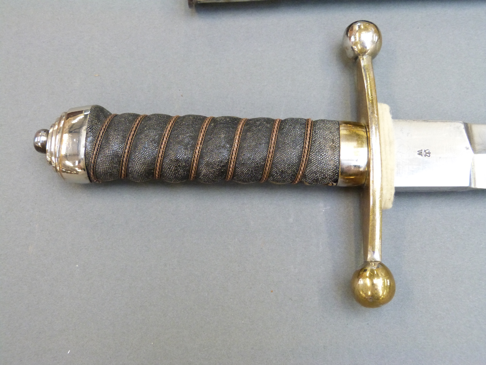 A 19thC Wilkinson 'handkerchief cutter' sword with leather scabbard