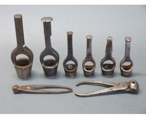 Six various wad punch tools together with two pairs of bullet moulds