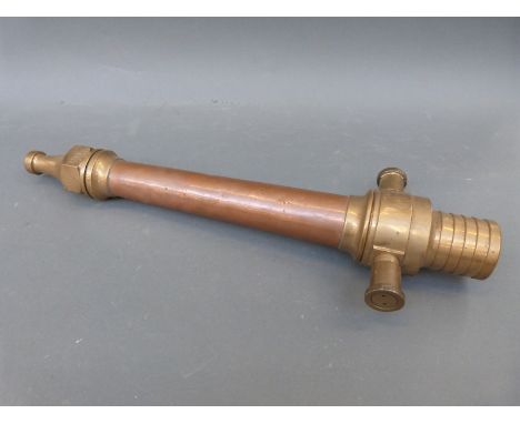 A vintage copper and brass fire hose nozzle with adjustable side valves, length 55cm