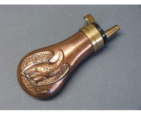 Copper and brass pistol powder flask with embossed decoration of an American style eagle holding a revolver and a powder flas