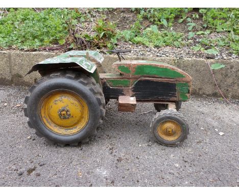 A large scale wooden model of a John Deere tractor with green body and yellow wheels, 45cm long