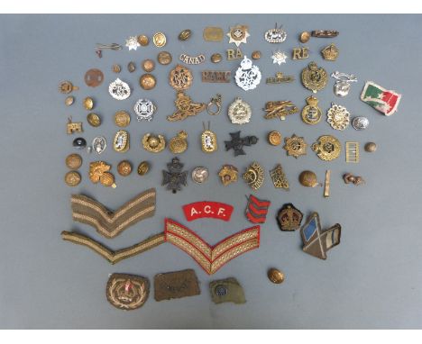 A quantity of British WWI and WWII cap badges, insignia etc including Royal Engineers, Naval, Canada, Indian Army etc