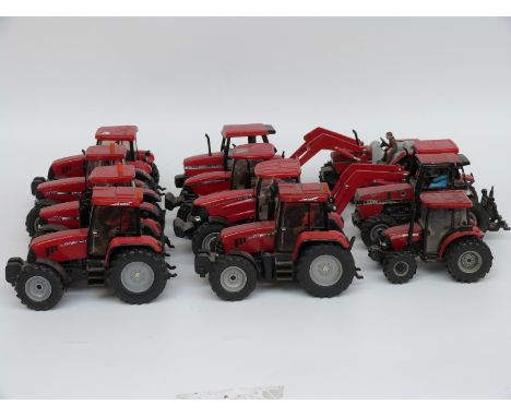 Twelve Britains and similar 1:32 scale diecast and plastic model Case tractors, some with loading implements and drivers