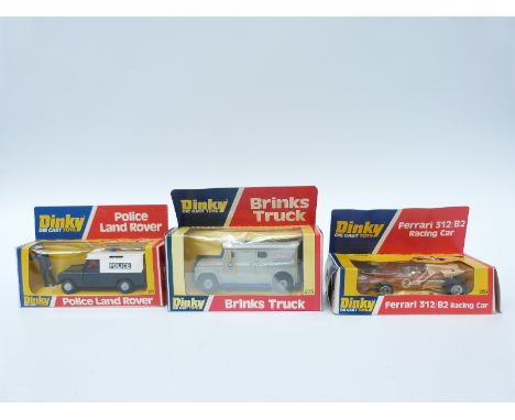 Three Dinky Toys diecast model vehicles comprising Ferrari 312/B2 Racing Car 226, Brinks Truck 275 and Police Land Rover 277,