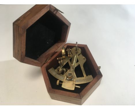 A reproduction navy brass sextant in a fitted box.